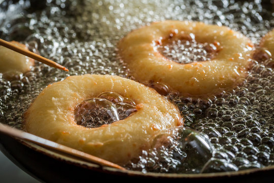 Frying sweet and tasty donuts on hot oil