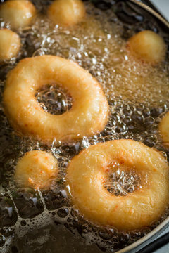 Frying tasty and homemade donuts on fresh oil