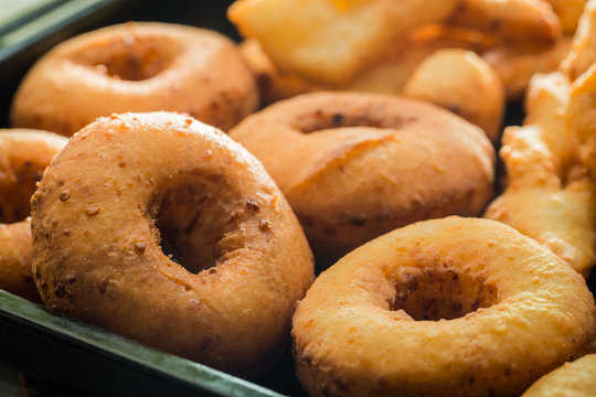 Homemade and delicious golden donuts with powdered sugar