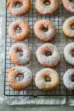 Yummy and homemade golden donuts with powdered sugar