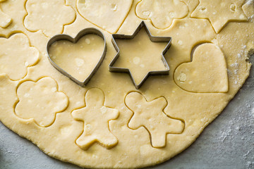Cutting from fresh dough tasty milky biscuits