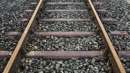 closeup of train tracks and stones