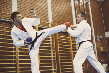 Two young males practicing judo together.