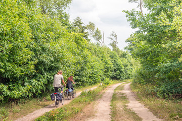 Fototapeta premium Man and woman cycling in a large nature reserve