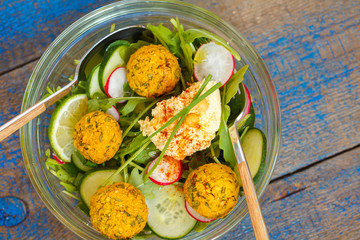 Vegetarian green salad with falafel and hummus. Love for a healthy vegan food concept.