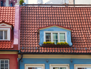 Window with flowers in the roof of an old house in the old town in Riga, Latvia