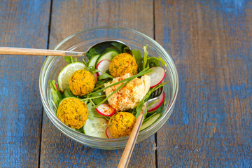Vegetarian green salad with falafel and hummus. Love for a healthy vegan food concept.