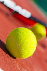 Tennis balls and racket on the grass court