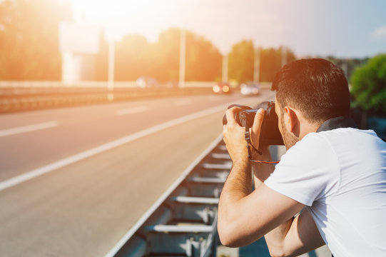 Man photographing highway road