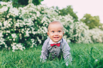 Cute baby crawling in the grass