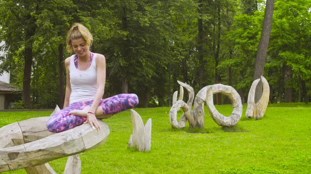 Young woman doing yoga exercises in the park