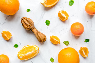 Fresh orange fruits with mint on table background top view patte