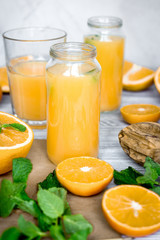 Naklejka na ściany i meble healthy morning with orange juice in bottle on kitchen backgroun