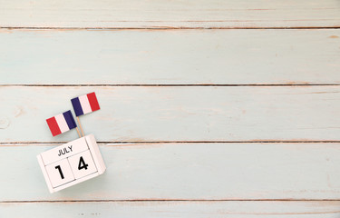 Fototapeta na wymiar 14 july Wooden calendar Happy Bastille Day. Concept National Day France,Copy space,minimal style and vintage style