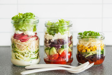 healthy vegetable and cheese salad in mason jars