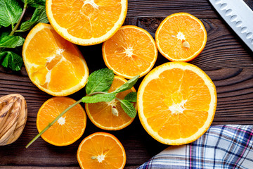 orange juice with mint squeezing on wooden kitchen background to