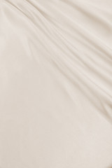 Naklejka premium Smooth elegant golden silk or satin luxury cloth texture as wedding background. Luxurious background design. In Sepia toned. Retro style