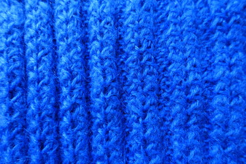 Vertical wales on bright blue handmade knitted fabric