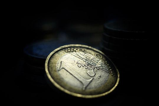 Old euro coin with cold lighting on dark background