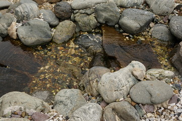 Obraz premium A small stone waterfall with several rapids and clear transparent spring water