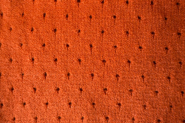 Orange cashmere stockinette fabric with perforated dots
