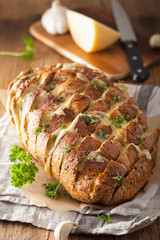 baked party bread with melted cheese butter herbs