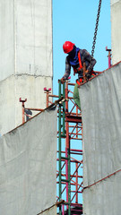 People working on construction site with yellow helmet