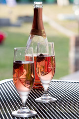 Wine glasses on table at garden in a sunny day
