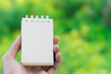 white paper or book on the tree bokeh background using wallpaper and background for  note