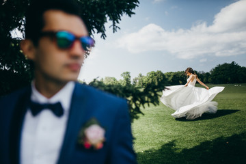 Happy bride and groom spending time in the park