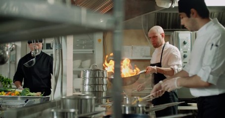 the workflow in the kitchen of the restaurant,a team of Asian chefs prepare dishes - Powered by Adobe