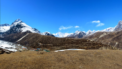 Panoramic view of the Cho-Oyu mountain ridge and Machhermo village. Himalayan mountains, Nepal