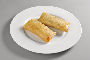 Round dish with dim sum spring rolls