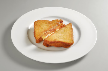 Round dish with fried mozzarella sandwich