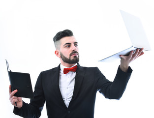 Businessman with beard or director with curious look holding laptop