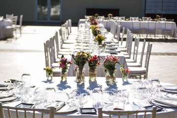 Close-up of tiny wedding bouquets on a restaurant table