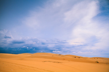 Fototapeta na wymiar White Desert At Mui Ne/ / Sunny Day With Blue Sky And Clouds On Sand Dune (White Desert) At Mui Ne Vietnam.