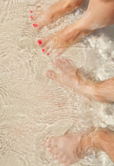 Fototapeta premium Feet in waves