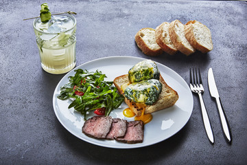 Corrugated egg and meat in a plate on the table, and a cocktail