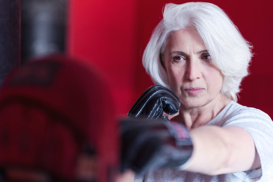 Close up of serious elderly woman boxing