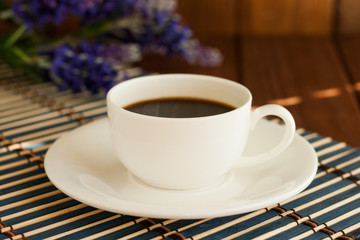 A cup of coffee on a wooden background