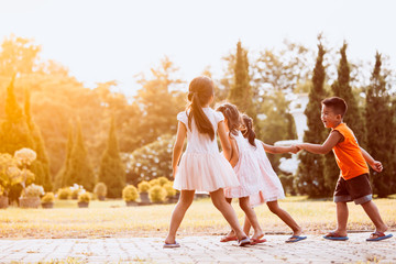 Asian children holding hand and walking together in the park in vintage color tone