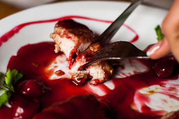meat with fresh herbs and cherry sauce, ready to eat.
