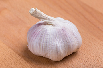 Close up texture of white and fresh raw garlic bulbs place on wooden table, valuable herbal for healthiness.