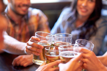 happy friends drinking beer at bar or pub