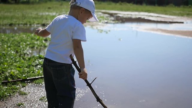 a child playing near the pond. games outdoors