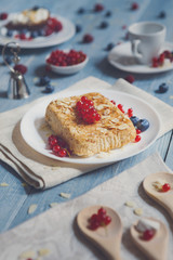 Pastry pie, tea, coffee and berries at blue rustic wood