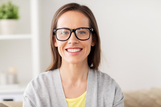 Happy Smiling Middle Aged Woman In Glasses At Home