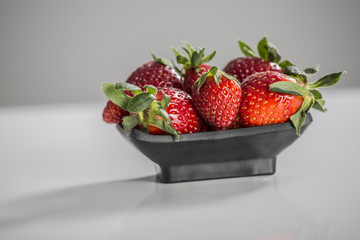 Juicy fresh strawberries in a white bowl