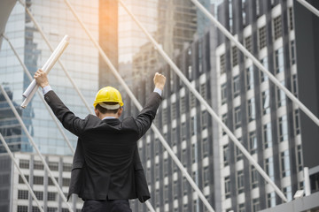 Professional Construction engineer Manager wear safety yellow helmet holding Blueprint feeling...